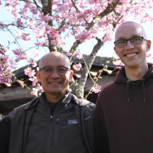 Three brothers in front of a blooming tree